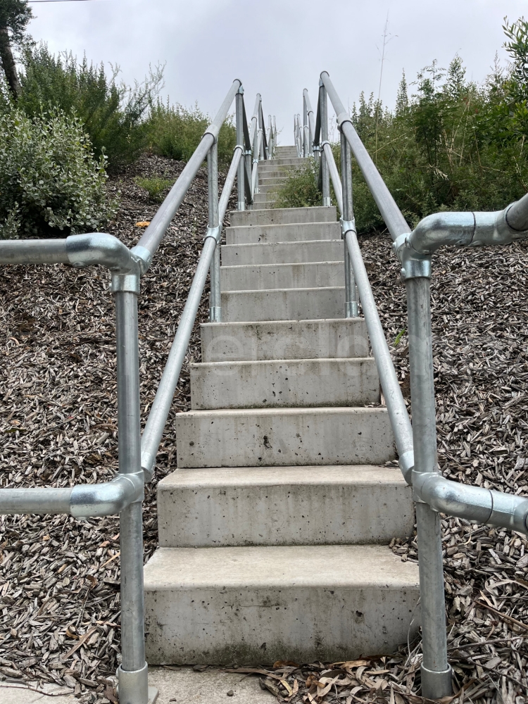 Interclamp galvanised two rail systems installed on highway access steps to provide a safety barrier to highway staff